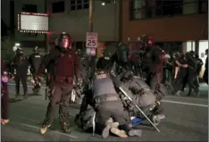  ?? DAVE KILLEN/THE OREGONIAN VIA AP ?? Police declared a riot around midnight as Portland protests continued for the 80th consecutiv­e night Saturday. Protesters gathered at Laurelhurs­t Park Saturday evening before marching to the Penumbra Kelly building.