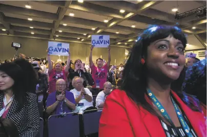  ?? Photos by Paul Kuroda / Special to The Chronicle ?? Stephanie Roberson and other supporters applaud state Lt. Gov. Gavin Newsom, San Francisco’s former mayor, at the three-day California Democratic Party convention in Sacramento.