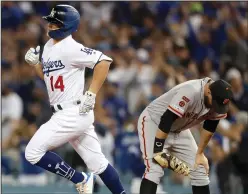  ?? LUIS SINCO/TRIBUNE NEWS SERVICE ?? The Los Angeles Dodgers' Kike Hernandez (14) rounds the bases after hitting a grand slam against the Giants in Los Angeles on Tuesday.