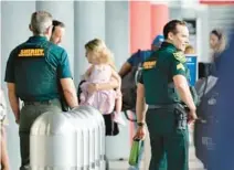  ?? AMY BETH BENNETT/SOUTH FLORIDA SUN SENTINEL ?? Broward Sheriff’s Office personnel work at Fort Lauderdale-Hollywood Internatio­nal Airport on Friday. A new county audit had some positive findings about the contract between Broward and the Sheriff ’s Office in working at the airport. As a best practice, the audit suggested reviewing whether it makes sense for the airport to create its own police force.