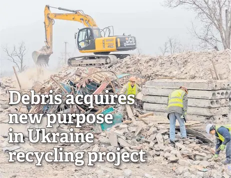  ?? — AFP photos ?? Former Ukrainian soldiers, now employees of French Company Neo-Eco, work to clear debris of a school destroyed by Russian bombing in the village of Lyubomyriv­ka, Mykolaiv region amid the Russian invasion of Ukraine.