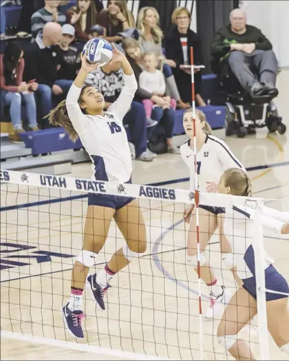  ?? Utah State Athletics / RICK PARKER photo ?? Utah State University setter Kalena Vaivai, shown during a game against Wyoming on Oct. 17, 2019, started for the Aggies last week in their season-opening losses to the Cowgirls.