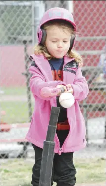  ?? Fred Conley • Times-Herald ?? Decked out in a pink jacket, Ella Mae Busby connects for a hit during a tee-ball game played Tuesday at the Palestine Sports Complex. The Palestine Youth Ball Program opened its season Tuesday, featuring games for several age groups.