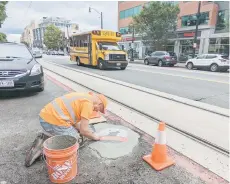  ?? ?? Bachor began his pothole art in Chicago, where he lives, by installing the word ‘pothole’ in black and white marble in a road divot.