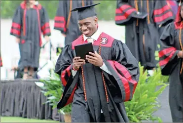 ?? Jeremy stewart ?? Cedartown High School graduate Rashad Walker reacts as he walks back to his seat after receiving his diploma during the school’s commenceme­nt ceremony Saturday, June 27.