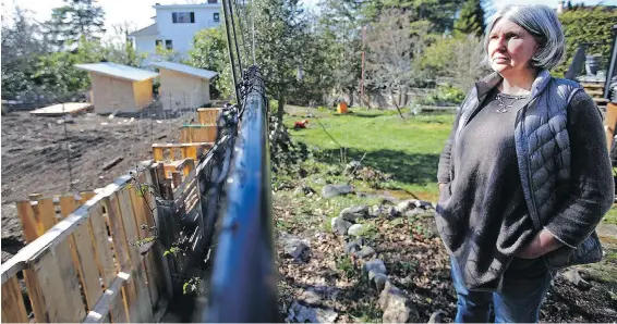  ?? ADRIAN LAM, TC ?? Chantal Meagher, in her Rockland backyard, is hoping her neighbours’ chicken plans don’t come home to roost, worrying the fowl will attract rats and vermin.