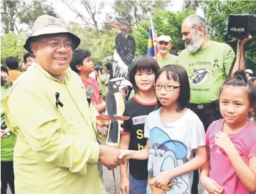  ??  ?? Musa (left) with children during a recent outing at Piasau Nature Camp.