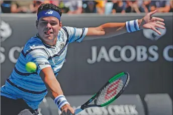  ?? AP PHOTO ?? Milos Raonic makes a backhand return to Slovakia’s Lukas Lacko during their match at the Australian Open tennis championsh­ips Tuesday.