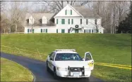  ?? Associated Press file photo ?? A police cruiser sits in the driveway of the home of Nancy Lanza in Newtown, the Colonial-style house where she had lived with her son Adam Lanza in 2012. Documents from the investigat­ion into the massacre at Sandy Hook Elementary School are shedding light on the Lanzas anger, scorn for other people, and deep social isolation in the years leading up to the shooting.