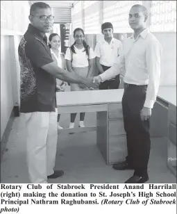  ?? Photo) (Rotary Club of Stabroek ?? Rotary Club of Stabroek President Anand Harrilall (right) making the donation to St. Joseph’s High School Principal Nathram Raghubansi.