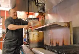  ?? STAFF FILE PHOTO ?? Chef Mike Adams, owner of Blue Orleans Seafood Restaurant, cooks jambalaya.