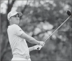  ?? The Associated Press ?? NEW NO. 1: Justin Thomas hits from the ninth tee Sunday during the final round of The Players Championsh­ip in Ponte Vedra Beach, Fla. Thomas tied for 11th in the tournament to move to No. 1 in the world rankings.