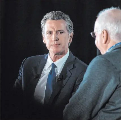  ?? Nic Coury The Associated Press ?? California Gov. Gavin Newsom, left, has announced that he will model a proposal in his state to essentiall­y ban the sale of assault weapons after the controvers­ial Texas abortion law, known as SB8.