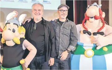  ??  ?? Conrad (left) and French writer and designer Jean-Yves Ferri pose with effigies of Asterix and Obelix during a press conference for the release of the comic’s new album ‘Asterix et la transitali­que’, in Paris. — AFP photo