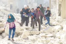  ?? — Reuters ?? People leave damaged site after an air strike on rebel-held Idlib city, Syria, on Sunday.