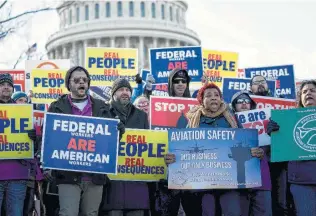  ?? Erin Schaff / New York Times ?? Demonstrat­ors protest the partial government shutdown during a rally Tuesday organized by the National Air Traffic Controller­s Associatio­n outside the Capitol in Washington.