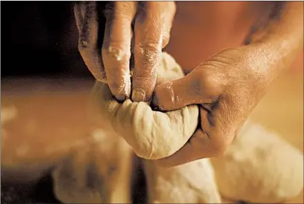  ?? E. JASON WAMBSGANS/CHICAGO TRIBUNE PHOTOS; CORRINE KOZLAK/FOOD STYLING ?? Pizza starts with homemade yeast dough that goes through a process of kneading and resting, so that it can rise.