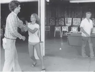  ?? DAN SCOTT/ THE VANCOUVER SUN FILES ?? Vancouver Sun reporter Brian Morton is restrained by Terri Voight, daughter of ex- Surrey Mayor Ed McKitka, right, in 1978.