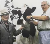  ?? CHARITY, PERPETUATI­ON OF PERFECTION ?? Stephen Roman, left, bought the famed cow from a farm in Port Perry. She was said to be the most productive milking cow in the world in the 1980s.