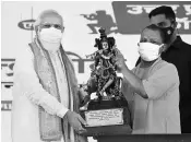  ?? PHOTO: PTI ?? Prime Minister Narendra Modi being presented a memento during foundation stone laying of Raja Mahendra Pratap Singh State University, in Aligarh, on Tuesday