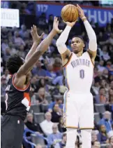  ??  ?? OKLAHOMA CITY: Oklahoma City Thunder guard Russell Westbrook (0) shoots over Portland Trail Blazers forward Al-Farouq Aminu, left, in the second quarter of an NBA basketball game in Oklahoma City, Tuesday. —AP