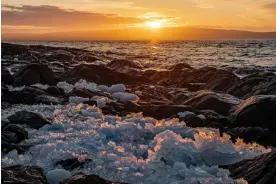  ?? ?? The remains of sea ice on the shore. Climate change is drasticall­y shortening winters on the Nunatsiavu­t coastline, where Canada’s Arctic really begins