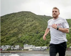  ?? ROSA WOODS/STUFF ?? Harry Cunningham trains on Wellington’s south coast in preparatio­n for a 250km footrace across the African desert in April.