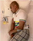  ??  ?? Peaceful: Track cyclist Azizulhasn­i Awang sleeping with the gold and silver medals won at the Asian Track Cycling Championsh­ips in Jincheon, South Korea, beside him.