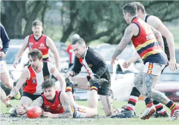  ??  ?? Longwarry’s Jake Serong forces the ball out in wet conditions at Western Park; Photograph­s: Michael Robinson.