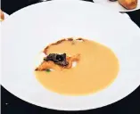  ??  ?? Grandma turkey cream soup with egg flower, black truffle and its crispy skin.