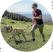  ?? STACY SQUIRES/STUFF ?? Grant Hambly takes his dog Oscar for a stroll on the Port Hills near Christchur­ch.