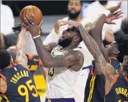  ?? MARK J. TERRILL – THE ASSOCIATED PRESS ?? The Lakers’ LeBron James, who scored 19 points, is fouled by Warriors guard Kelly Oubre Jr., right, while going up for a shot Sunday night at Staples Center.