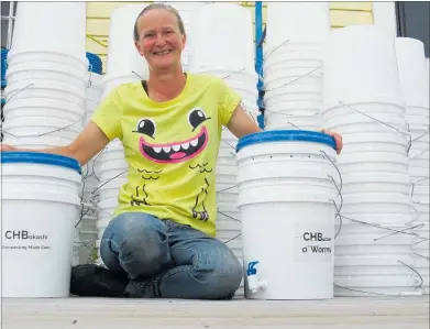  ??  ?? Avid recycler Neen Kennedy of Sustainabl­e Ewe, with some of the group’s “rescued” buckets that are being turned into CHBokashi and CHBucket o’ Worms composting kits.