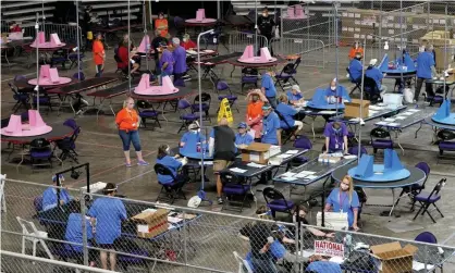  ??  ?? Maricopa county ballots cast in the 2020 general election are examined and recounted by contractor­s working for Florida-based company, Cyber Ninjas. Photograph: Matt York/AP