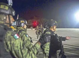  ?? AP ?? Mexican troops arrive at a military base in Culiacan, Mexico on Friday.