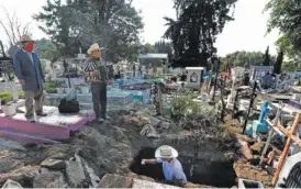  ?? AP PHOTO/MARCO UGARTE ?? Cemetery musician Victor Dzib Cima, 70, plays his accordion as he waits for clients Friday while cemetery workers remove coffins from gravesites that belonged to families who stopped paying rent at the San Nicolas Tolentino Pantheon in the Iztapalapa area of Mexico City.