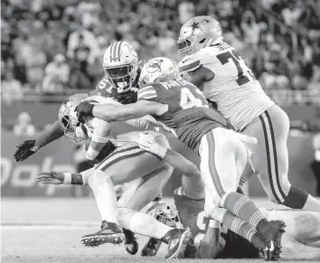  ?? DAVID SANTIAGO dsantiago@miamiheral­d.com ?? Dolphins defensive tackle Zach Sieler, on ground, linebacker Andrew Van Ginkel (43) and linebacker David Long Jr., top left, take down Cowboys quarterbac­k Dak Prescott in the second quarter Sunday.