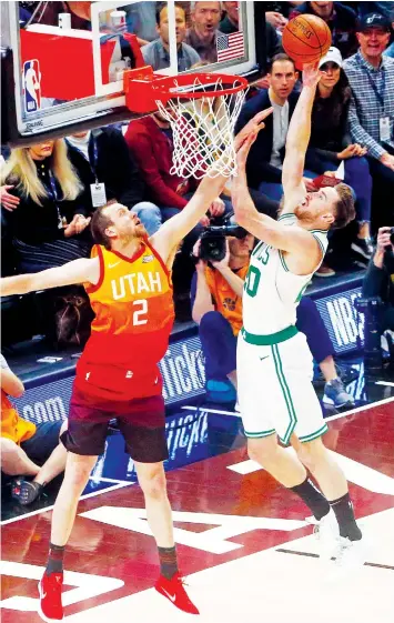  ??  ?? Boston Celtics forward Gordon Hayward (20) goes to the basket as Utah Jazz forward Joe Ingles (2) defends in the first half during an NBA basketball game in Salt Lake City. ASSOCIATED PRESS