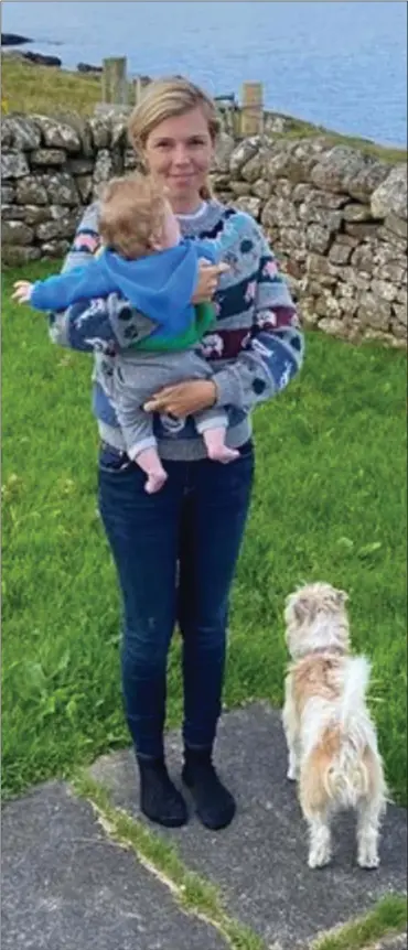  ??  ?? MUMMY’S BOY: Carrie, in a cosy knitted jumper and jeans, cuddles Wilfred for a snap, as Dilyn waits