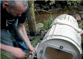  ??  ?? Marty Todd never pays a power bill, thanks to the hydro power provided by a stream on his property and two washing machine generators.