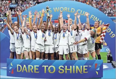  ?? AP - Alessandra Tarantino ?? The U.S. women’s soccer team celebrates after beating the Netherland­s in Sunday’s Women’s World Cup final. Megan Rapinoe — winner of the Golden Ball as the tournament’s top player — and Rose Lavelle each scored as the Americans clinched their second straight championsh­ip.