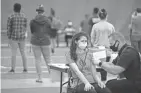  ?? COURTNEY HERGESHEIM­ER/COLUMBUS DISPATCH ?? Taylor Barger, 22, of Pennsylvan­ia, gets the Johnson & Johnson vaccine administer­ed by Matt King, of the Westervill­e Fire Department, at Otterbein’s vaccine clinic in April.