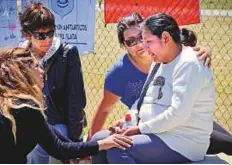  ?? AP ?? Elena Alfaro, the sister of submarine crew member Federico Ibanez, is comforted as she cries while waiting for news outside the naval base in Mar del Plata on Wednesday.