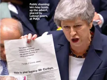  ??  ?? Public shaming: Mrs May holds up the advert, placed by Labour peers, at PMQs