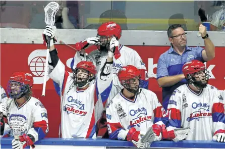  ?? CLIFFORD SKARSTEDT/EXAMINER ?? Peterborou­gh Century 21 Lakers players and coaches celebrate their 10-4 win over the Brooklin Redmen to take the series in six games during MSL semifinal action on Wednesday at the Iroquois Park Sports Complex in Whitby. They take on Six Nations for...