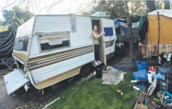  ?? Marcio Jose Sanchez, The Associated Press ?? A trailer resident onMonday receives an order to move out of a homeless encampment known as the Jungle in San Jose, Calif.