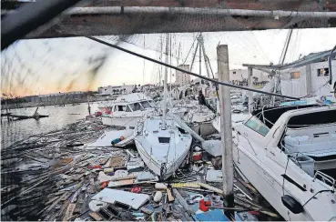  ?? [AP PHOTO] ?? Damaged boats sit among debris in a marina Friday in the aftermath of Hurricane Michael in Panama City, Fla.