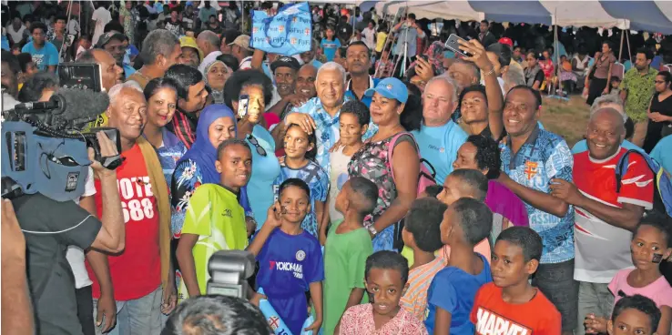  ?? Photo: Waisea Nasokia ?? Fijians flank FijiFirst party leader and Prime Minister Voreqe Bainimaram­a on November 9, 2018 at the party’s family fun day in Ba.