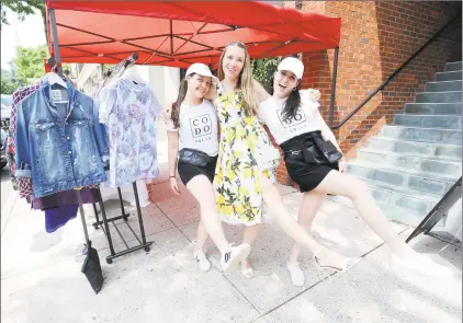  ?? Matthew Brown / Hearst Connecticu­t Media ?? Couture Dossier owner Yulia Omelich with employees on Thursday as Sidewalk Sales Days kicked off.