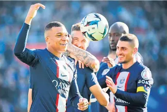  ?? — AFP photo ?? Mbappe (left) celebrates during the French Ligue 1 match between Paris Saint-Germain FC and AJ Auxerre at the Parc des Princes stadium in Paris.